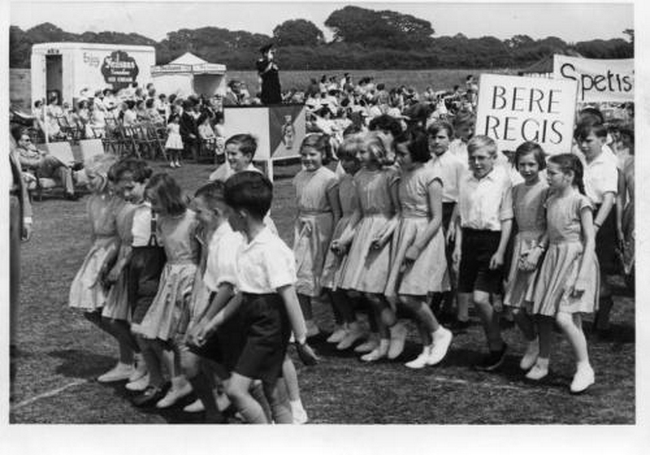 Schools march past in July 1961.